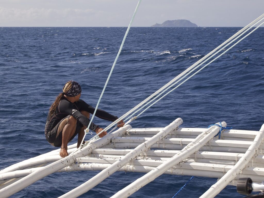 On the outrigger boat crossing to Apo Island, with the island on the horizon