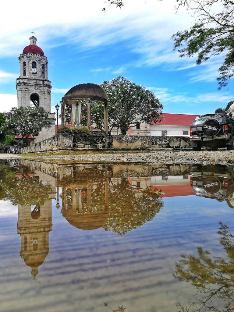Argao's church reflected in a rain pool on the plaza