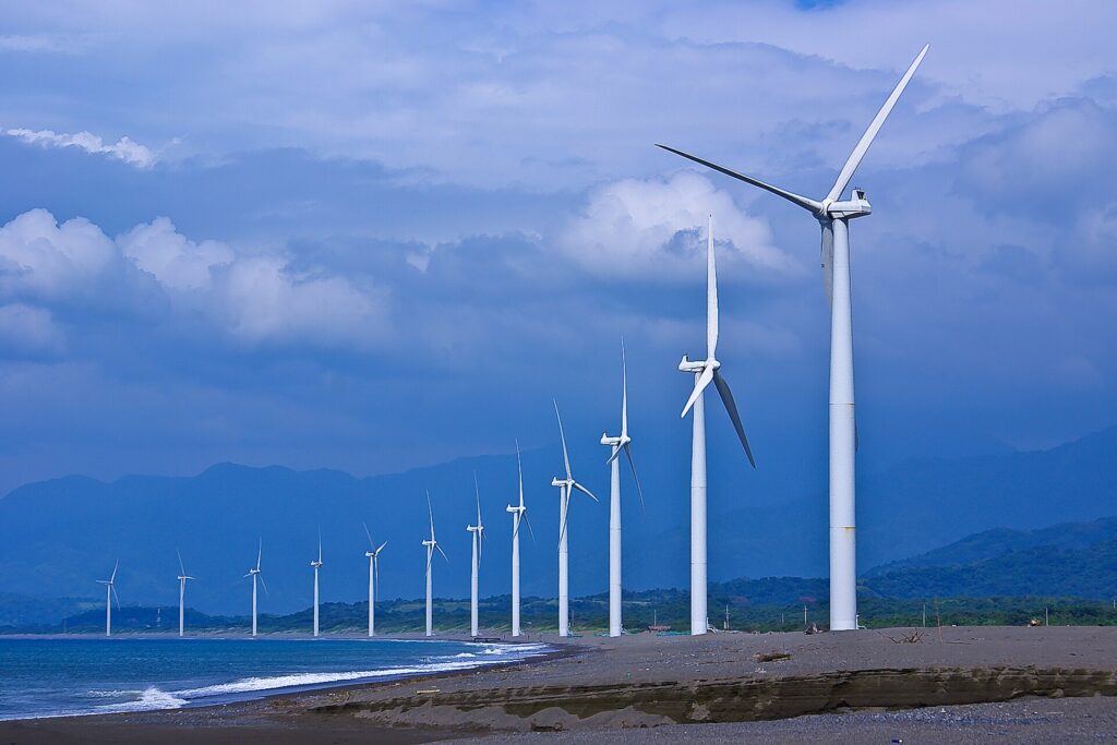The line of Bangui wind turbines curving along the shore of Bangui Bay