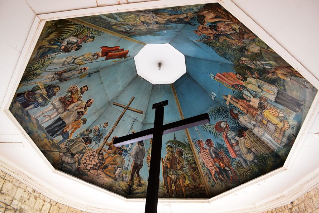 Magellan's Cross inside its octagonal kiosk beside the basilica