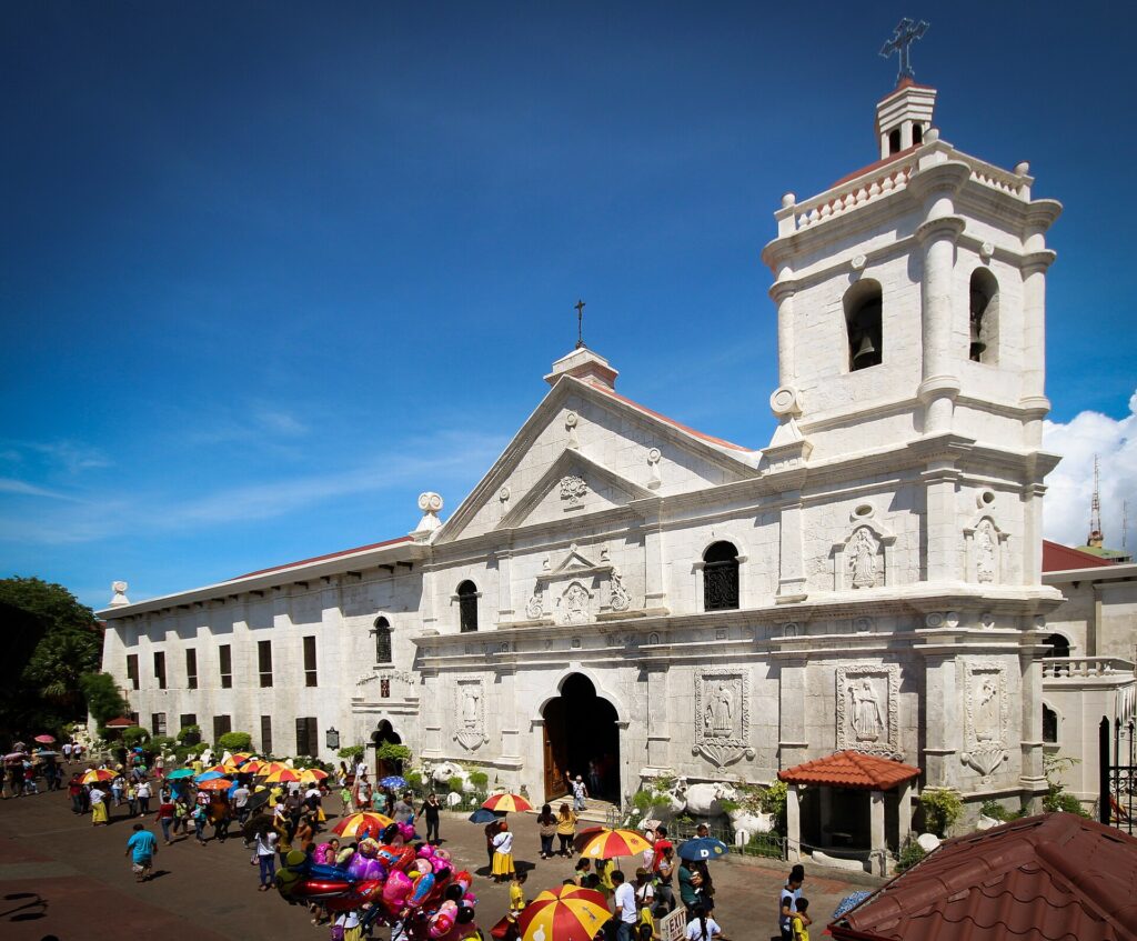 A wide view of the basilica's stone front and belfry