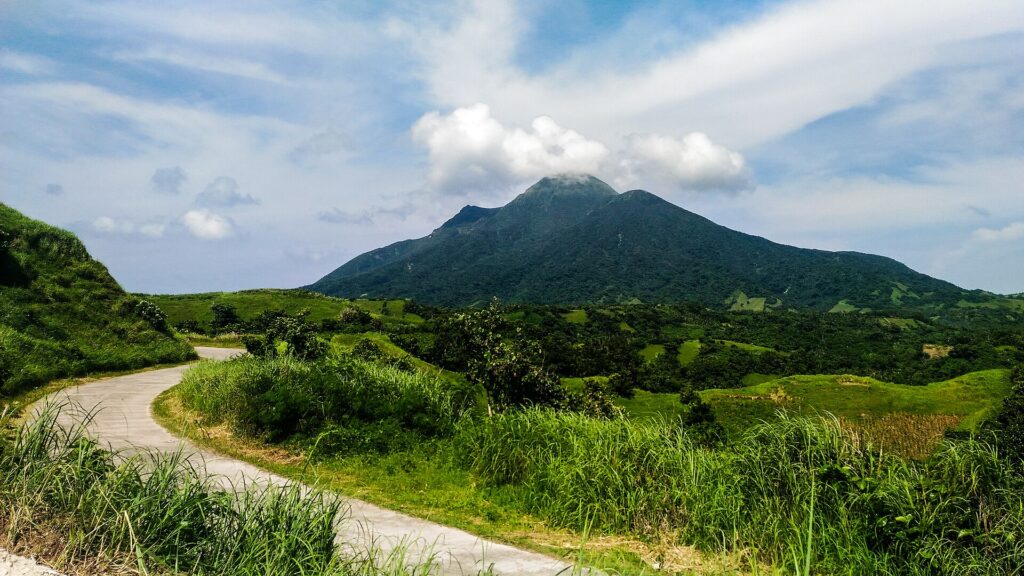 A quiet North Batan road with Mount Iraya rising behind
