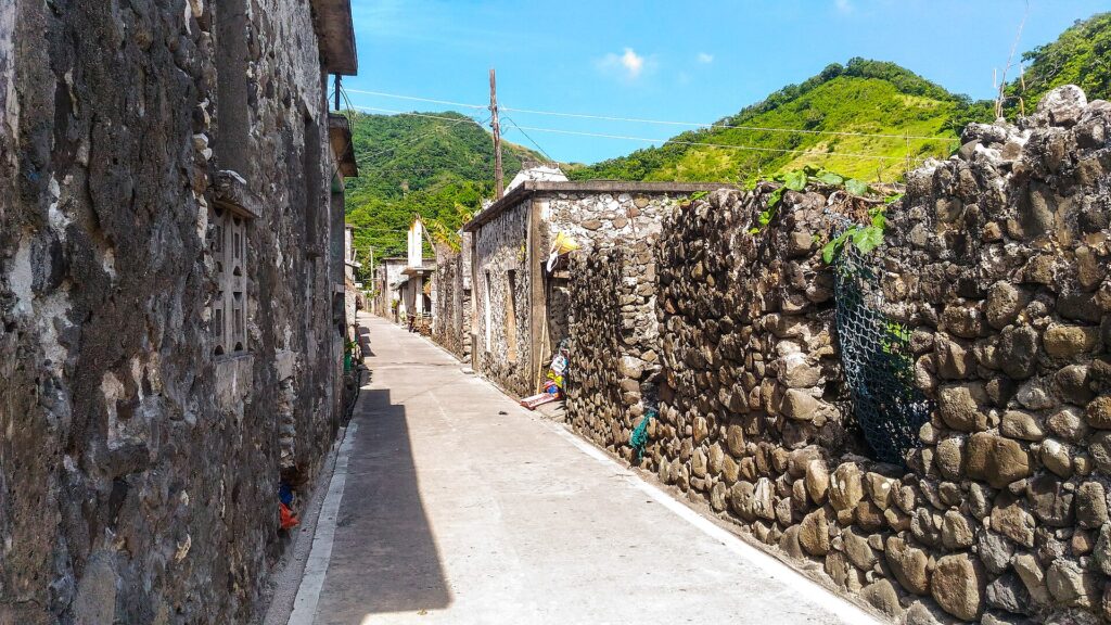 Lime-and-stone houses lining a lane in Sumnanga village, Sabtang Island