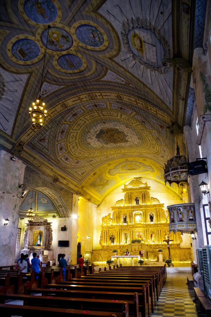 Painted ceiling and golden retablo inside Boljoon Church