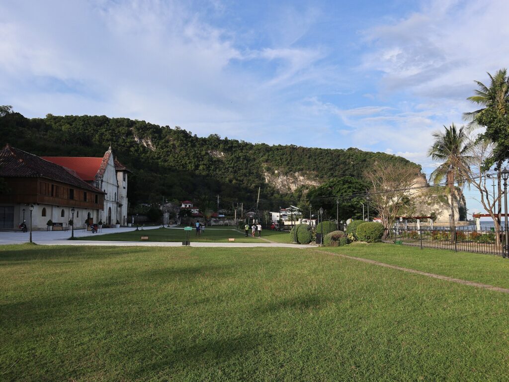 The church grounds with the limestone cliffs behind