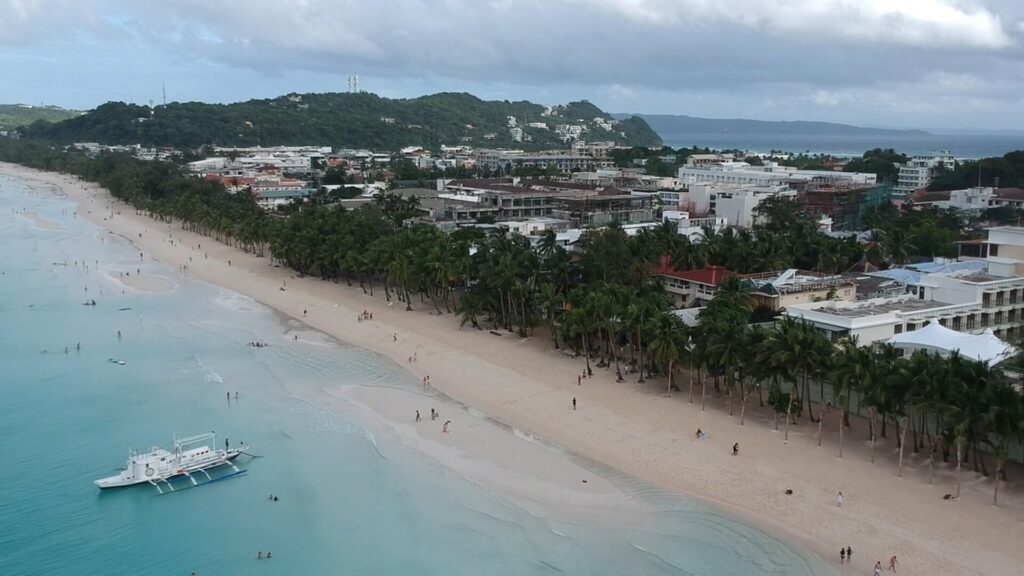 White Beach from the air, with the long line of sand and resorts behind it