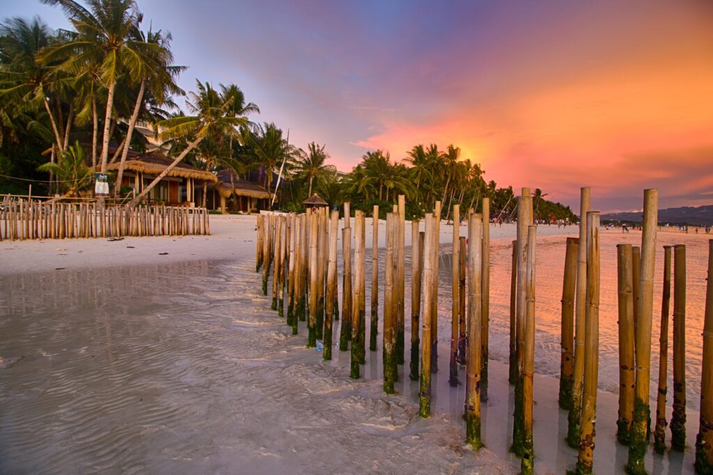 Bamboo poles along the shore at sunset on Boracay's coast
