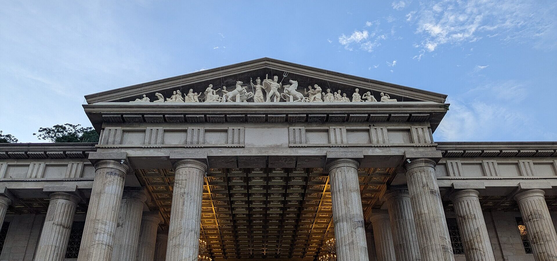 The columned facade and sculpted pediment of the Temple of Leah in Busay, Cebu City, against a blue sky