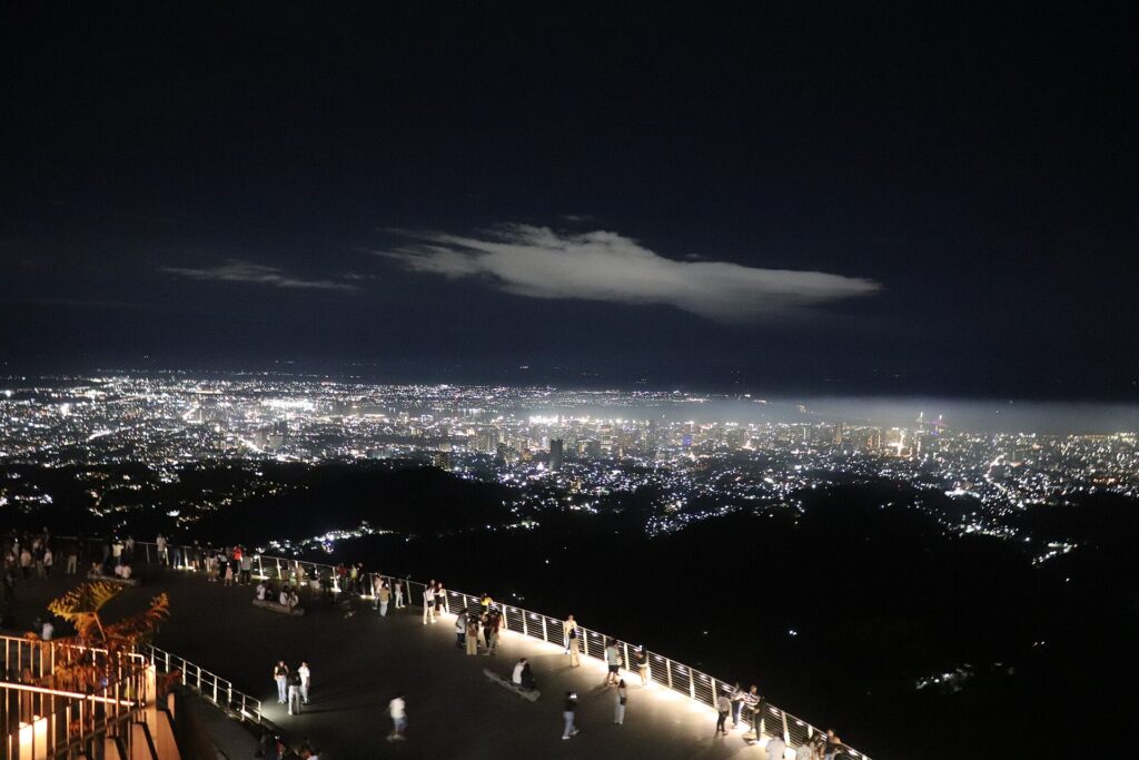 City lights glittering below Tops Lookout at night