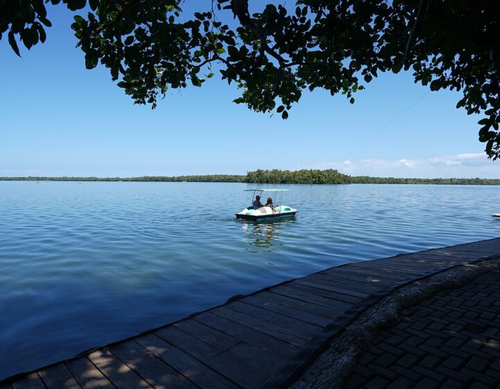 Lake Danao in San Francisco, Camotes, seen from the lakeside boardwalk with a pedal boat on calm blue water