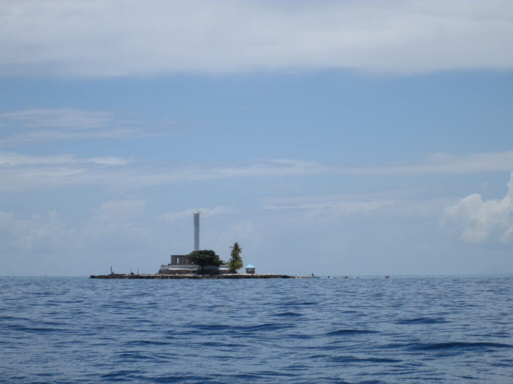 Capitancillo islet on the horizon, a speck in open sea