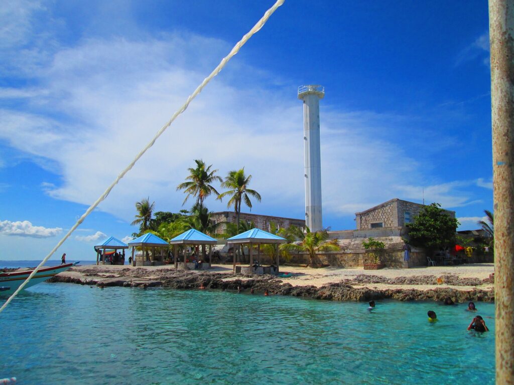 Turquoise water and cabanas around Capitancillo's lighthouse