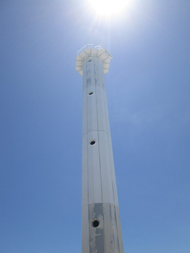 Looking up at the steel lighthouse tower in full sun
