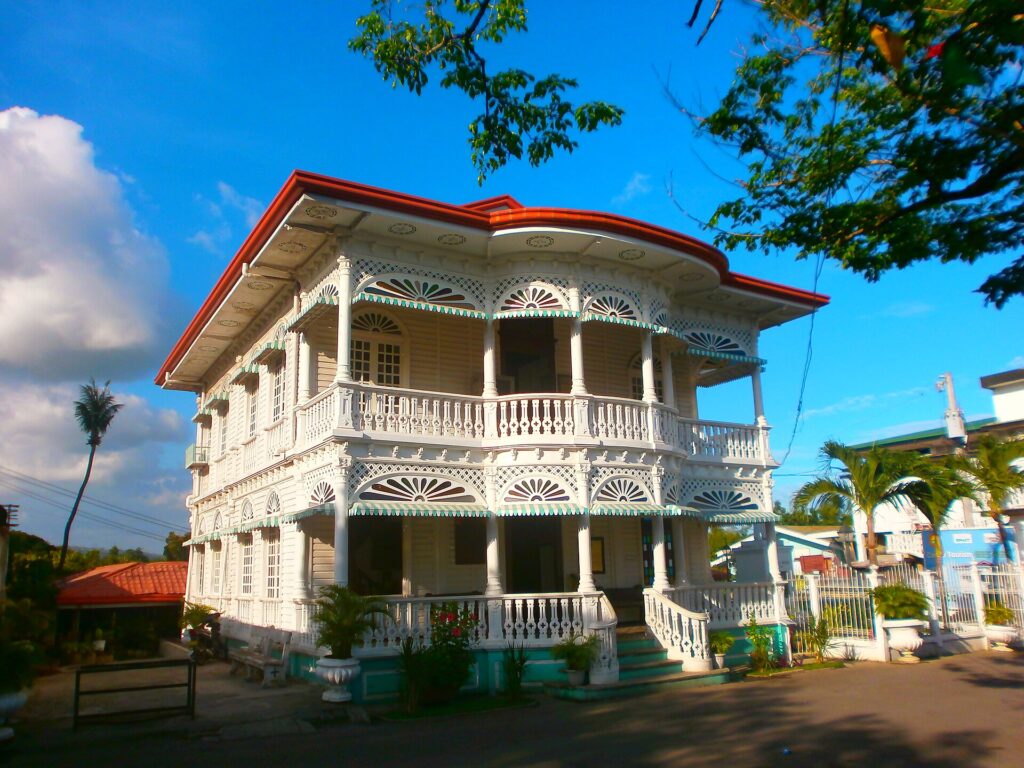 The white, lace-trimmed Carcar City Museum under a blue sky