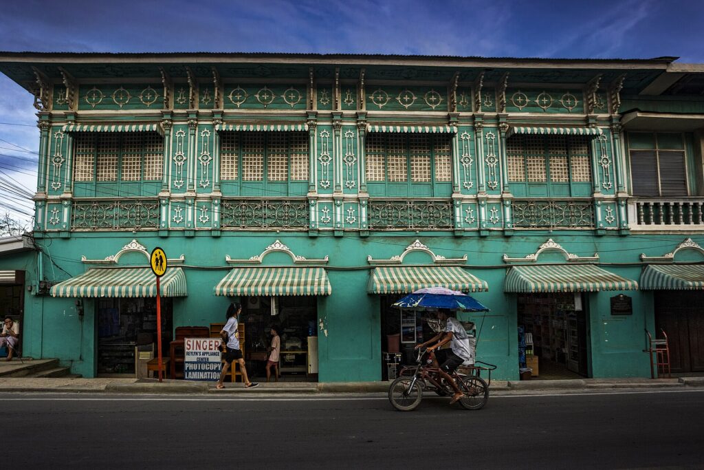 The green Mercado heritage house along the main road