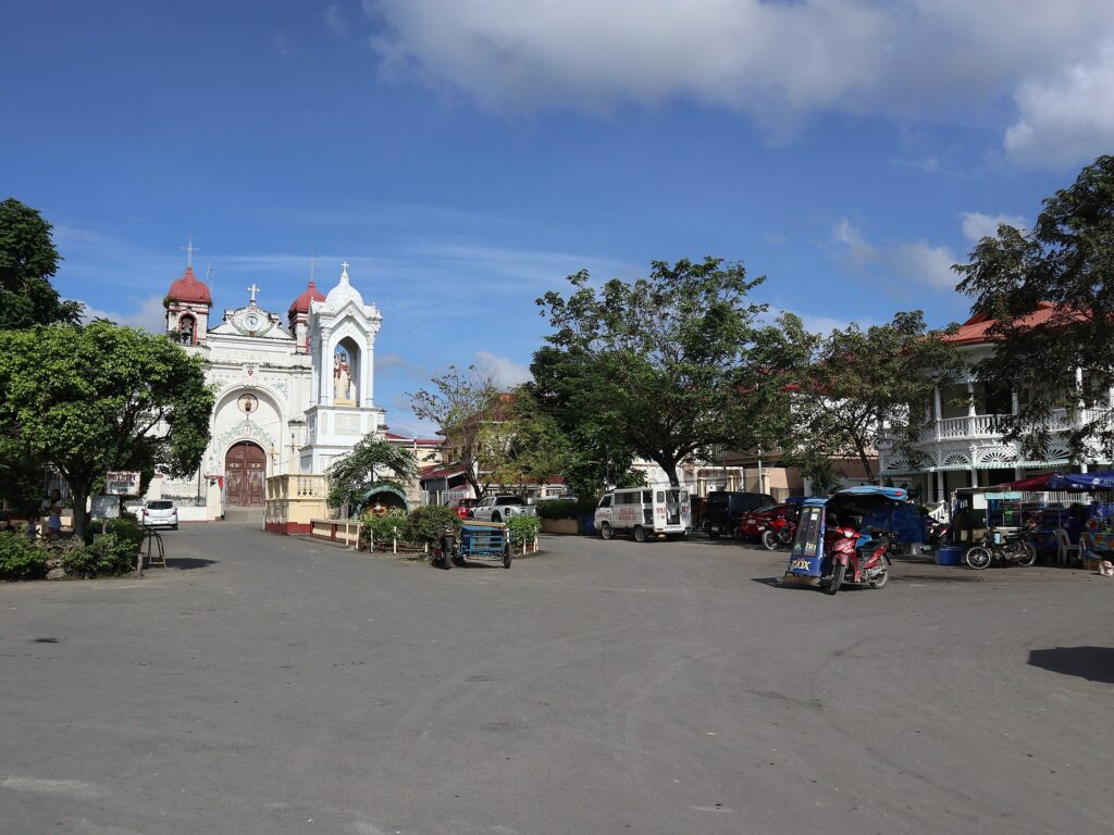 Carcar's town plaza with the church on the hill behind