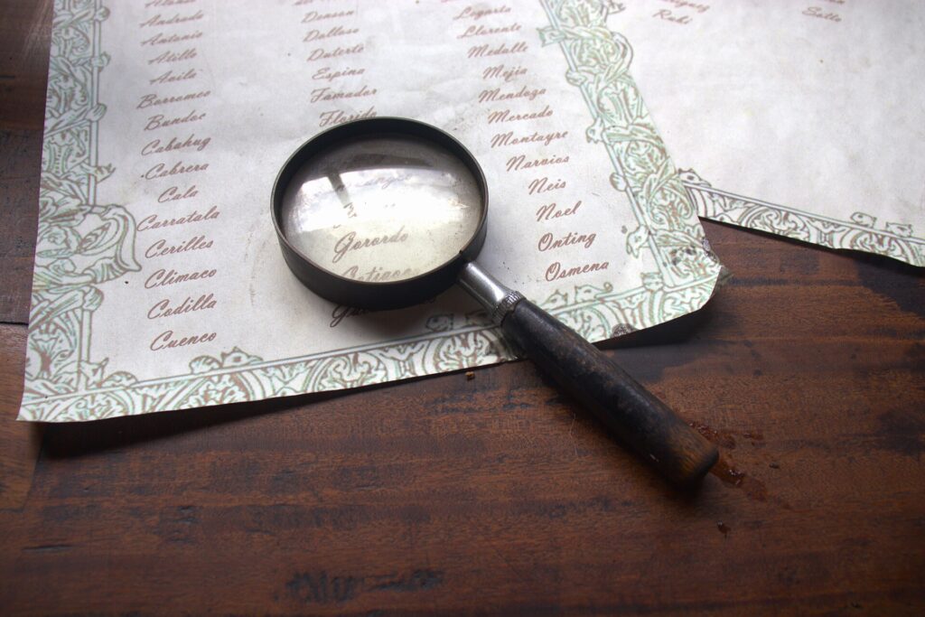 Old documents and a magnifying glass on a wooden table