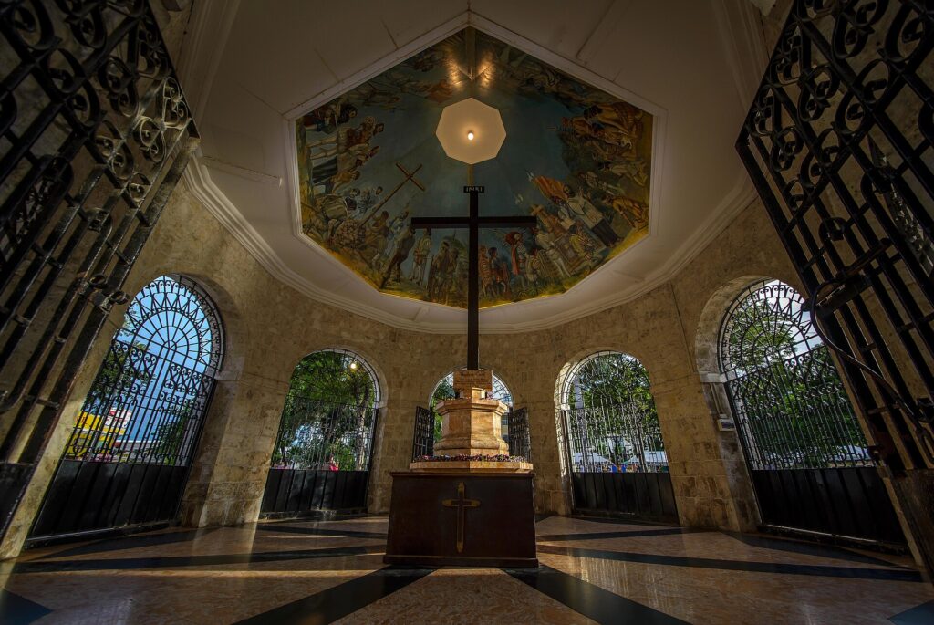 Magellan's Cross under the painted ceiling of its kiosk