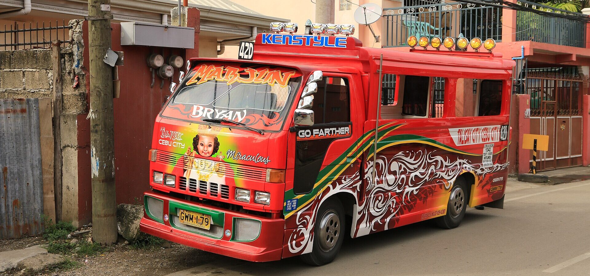 A colourful red jeepney on a street in Cebu City
