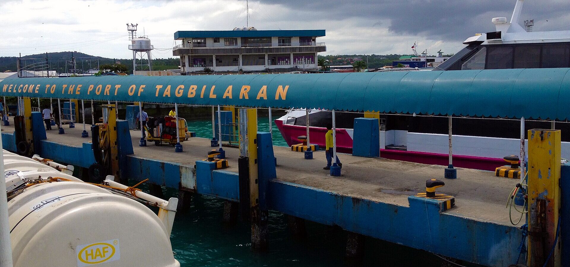 A passenger ferry at the Port of Tagbilaran in Bohol, with the "Welcome to the Port of Tagbilaran" sign