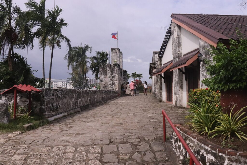 A cobbled path along the walls inside the fort, with a bastion ahead