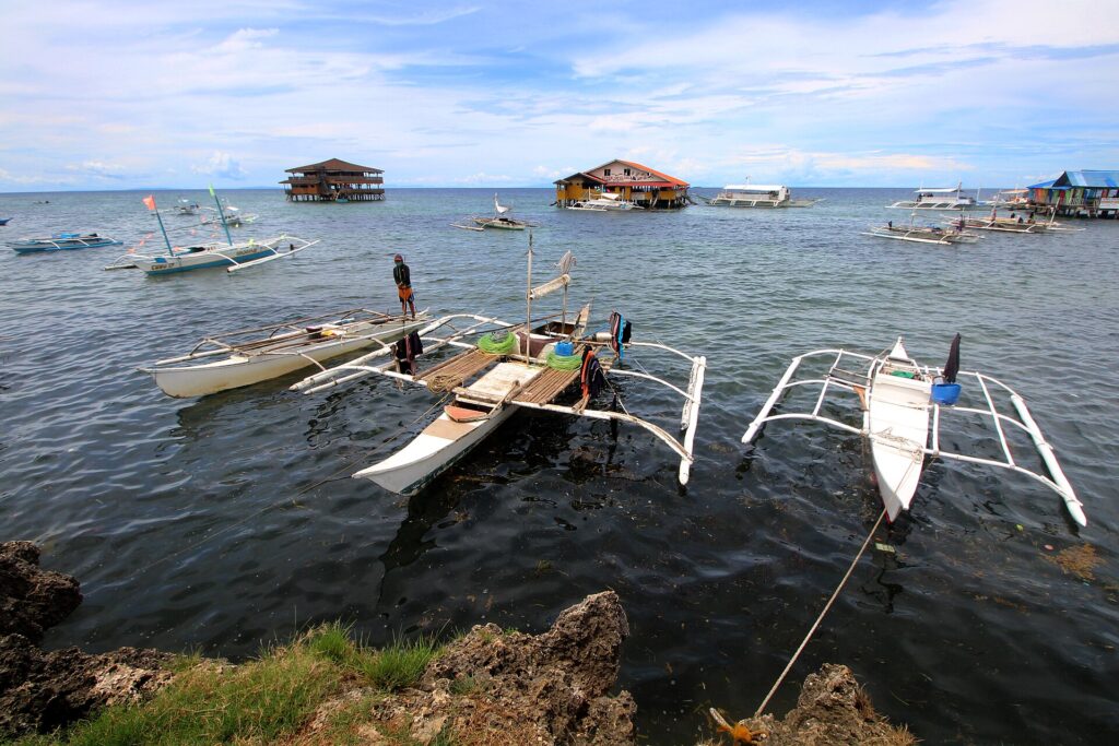 Outrigger boats and floating restaurants off Olango Island