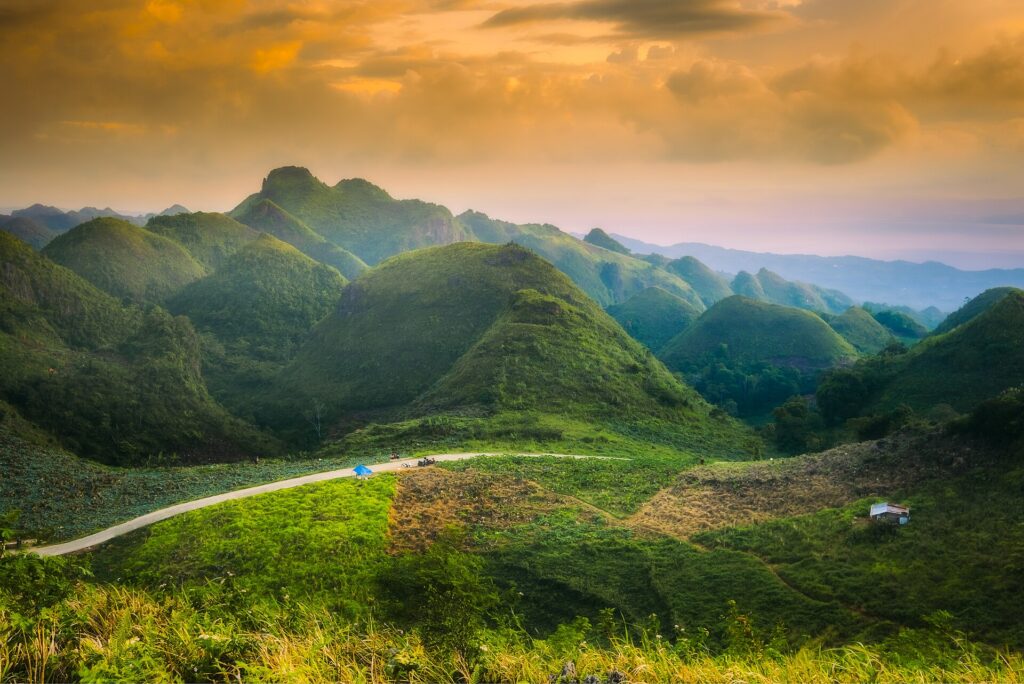 A winding road through the Badian Highlands at sunset