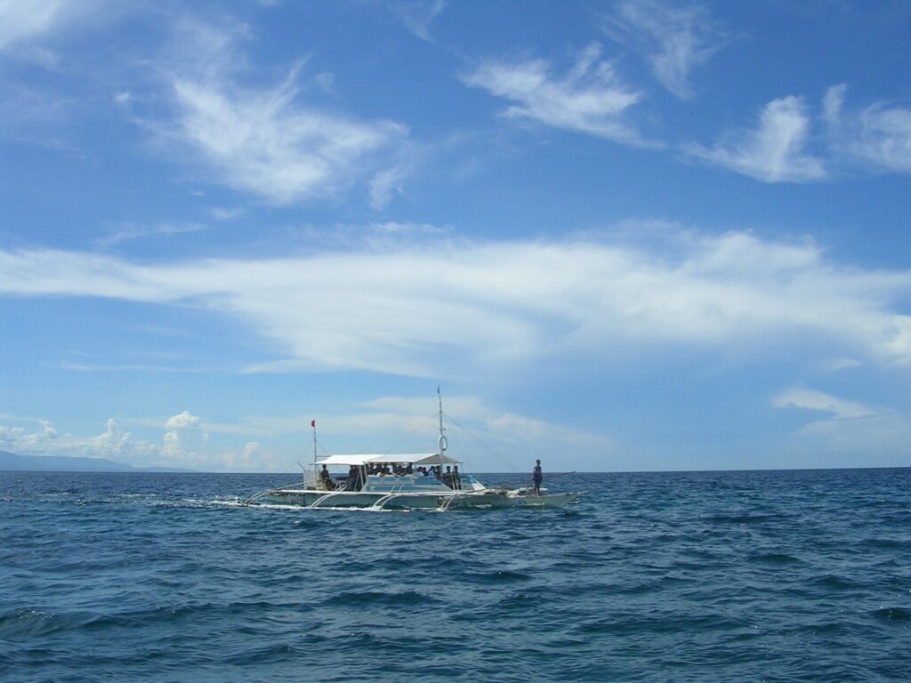 An outrigger boat crossing the sea near Olango Island