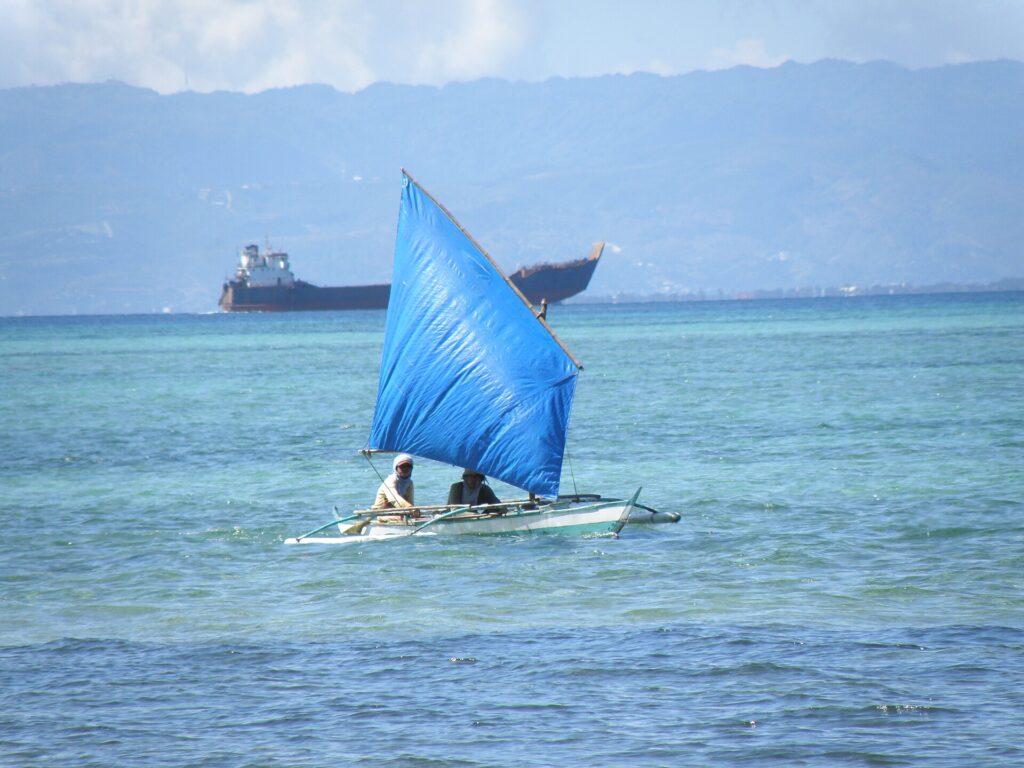 A traditional sail boat on turquoise water off Mactan