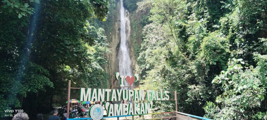 Mantayupan Falls behind the 'I love Mantayupan Falls Ambakan' sign