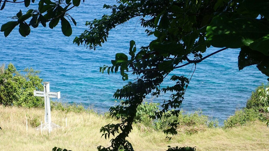 Palalong Memorial Cross above the blue sea in Barili