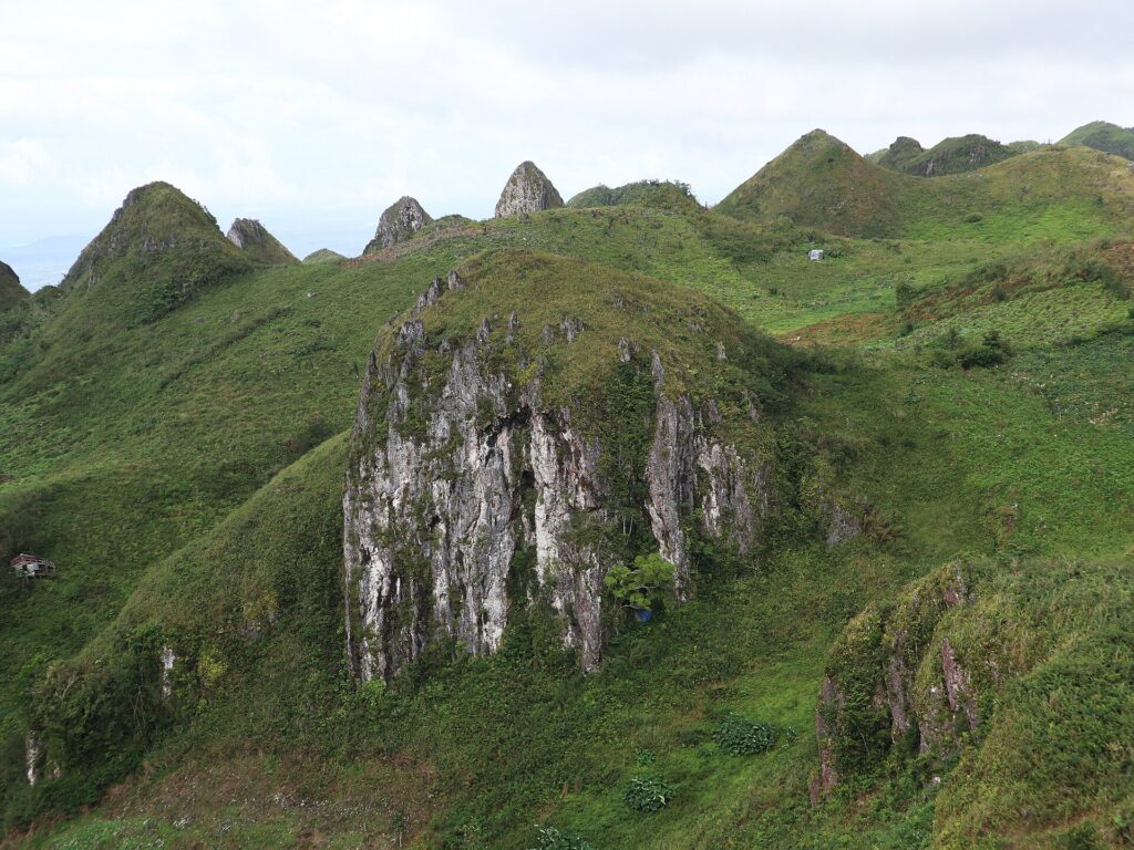 The pale Basiao rock formation among the green hills