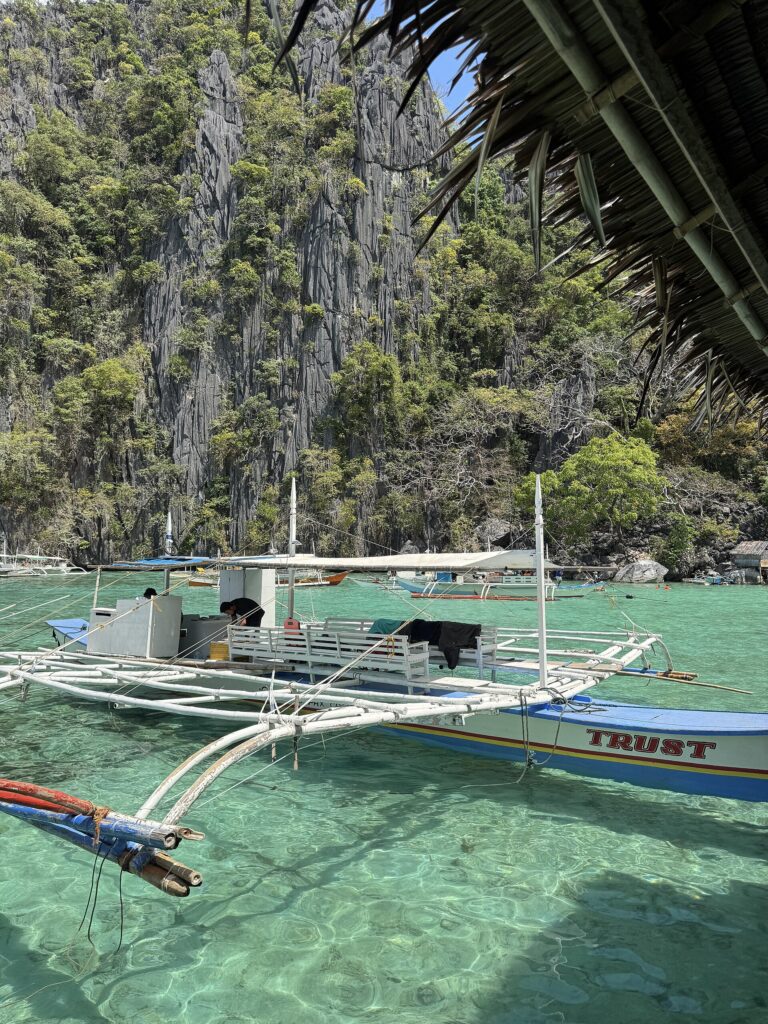 Bancas moored at Twin Lagoon under Coron Island's karst cliffs