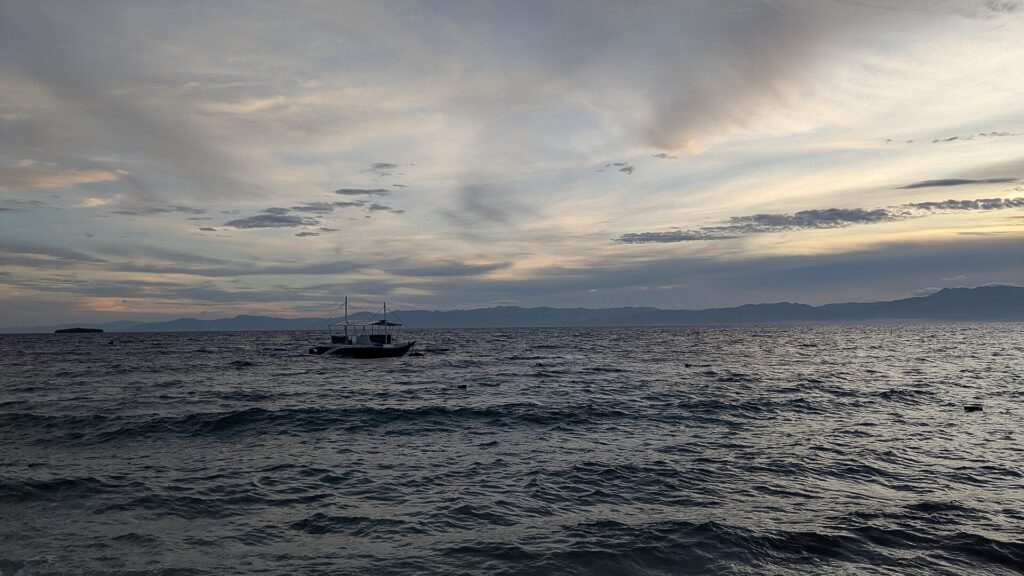 A bangka at anchor in the evening light off Panagsama