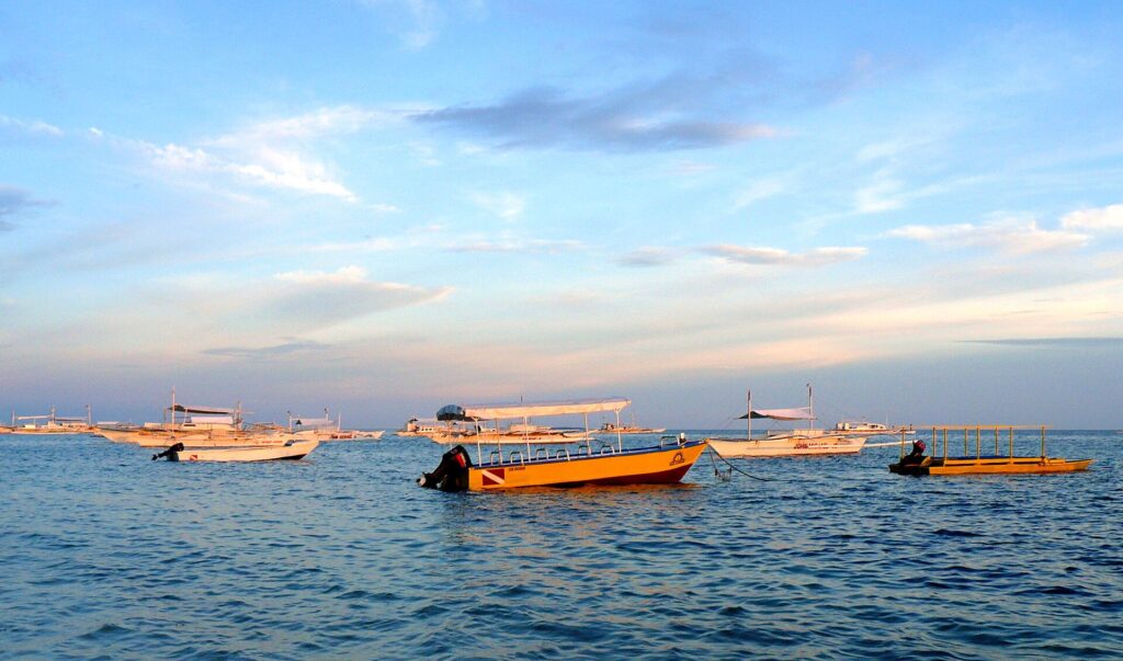 Bangka boats at anchor off Alona Beach in the late afternoon