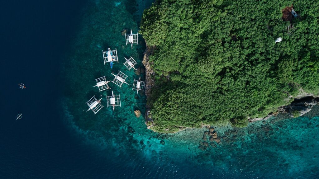 Bangka boats moored on the turquoise reef, seen from above