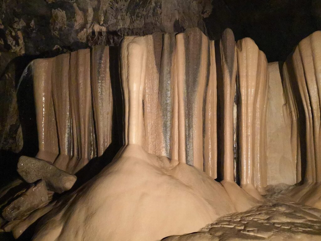 Flowing limestone formations deep inside Sumaguing Cave