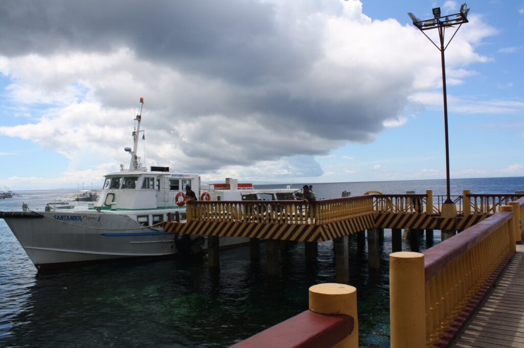 Boats and the yellow jetty at Liloan port, the crossing point to Negros