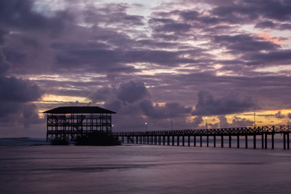 The Cloud 9 boardwalk and viewing tower in General Luna at sunrise