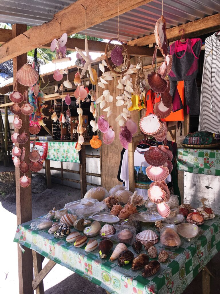 A roadside stand selling shells and handmade souvenirs