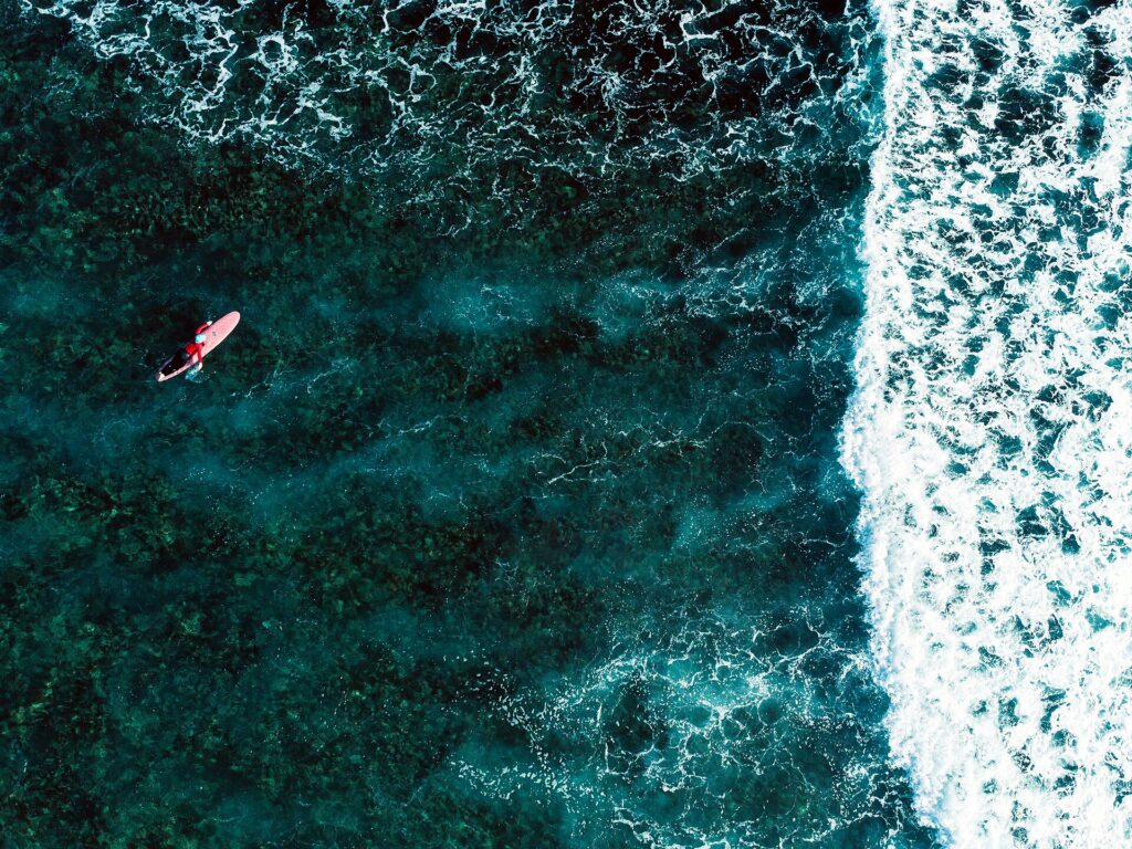 A surfer waits for a wave on the reef break off Siargao