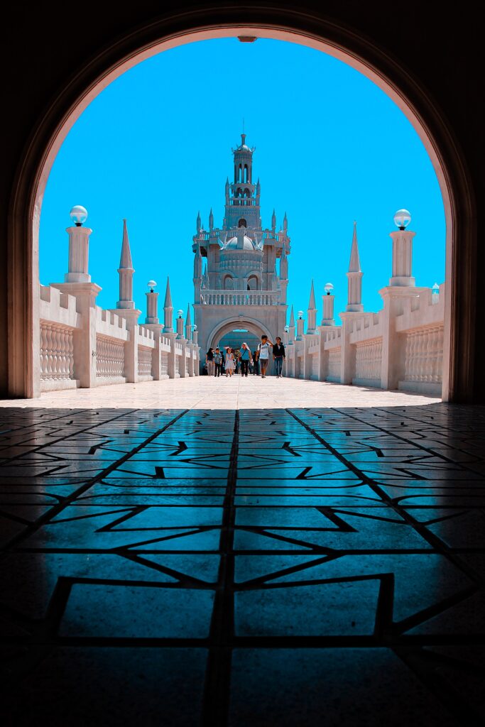 Looking through an arch along a long walkway at the shrine