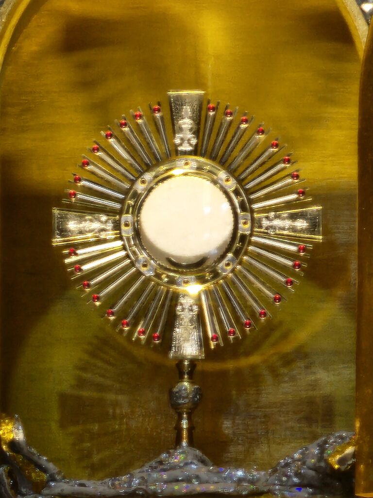 Golden monstrance during Eucharistic adoration at Simala