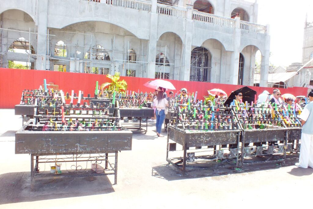 Rows of colourful prayer candles outside the shrine