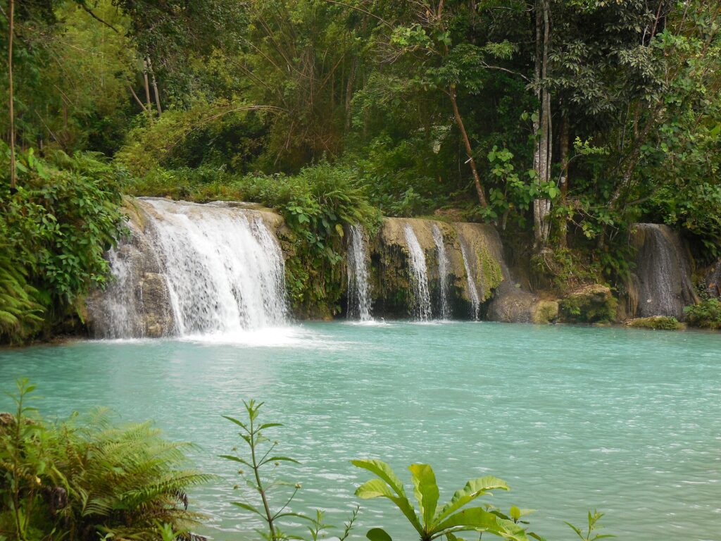 Cambugahay Falls in Lazi, tiers of water falling into turquoise pools
