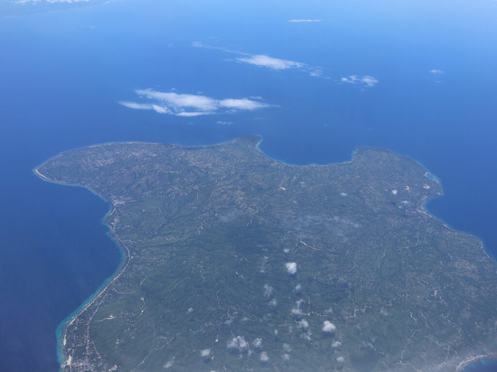 Siquijor Island seen from the air, ringed by reef and blue sea