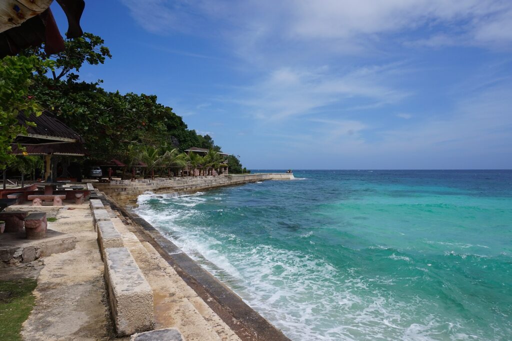 Clear turquoise water along the shore at Salagdoong Beach, Maria