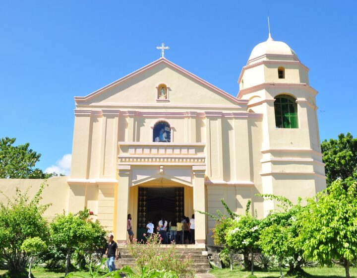 The cream facade and domed bell tower of St. James the Apostle Parish Church in Sogod, under a blue sky