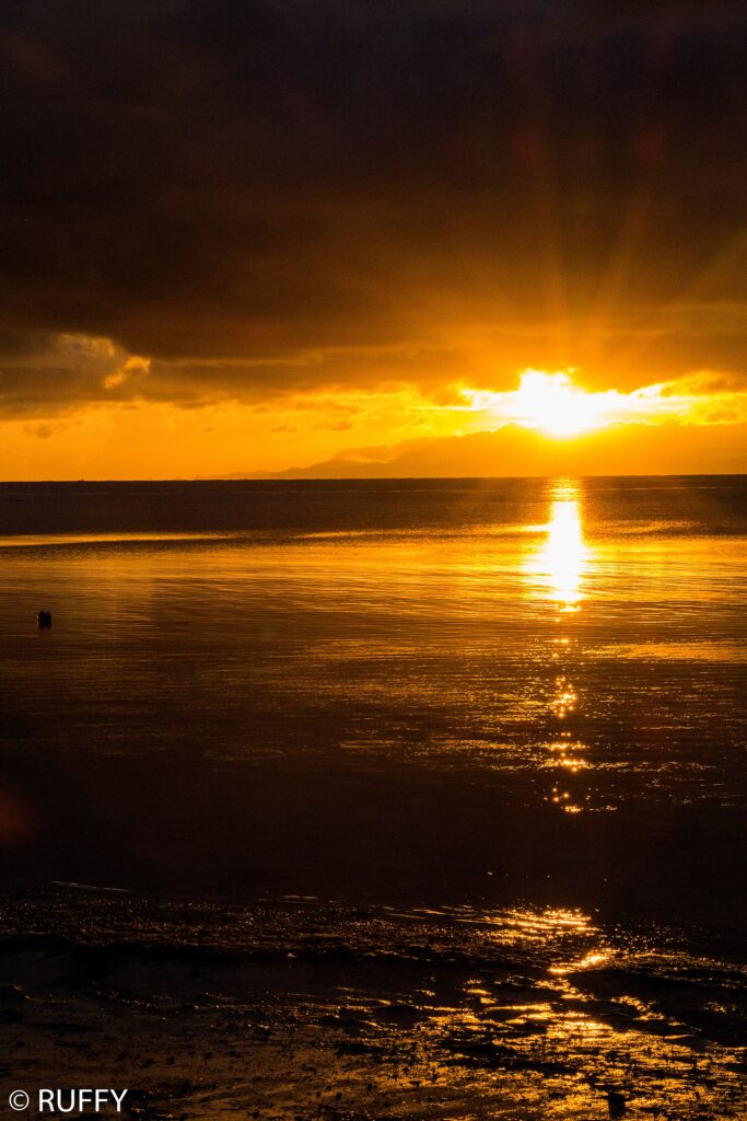 Golden sunrise over the water from the Alcoy shore