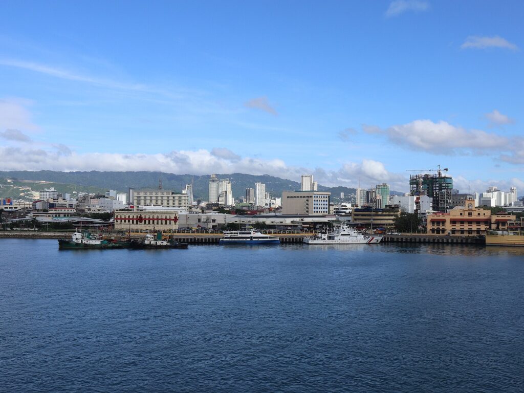 The Cebu City waterfront and skyline seen across the blue Mactan Channel